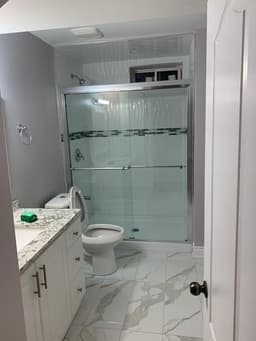 Bathroom Remodel Project in Toronto | Canvas Builds Toronto bathroom renovation with walk-in shower and tiled walls
