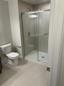 Bathroom Remodel Project in Toronto | Canvas Builds Modern glass shower enclosure in a Toronto bathroom