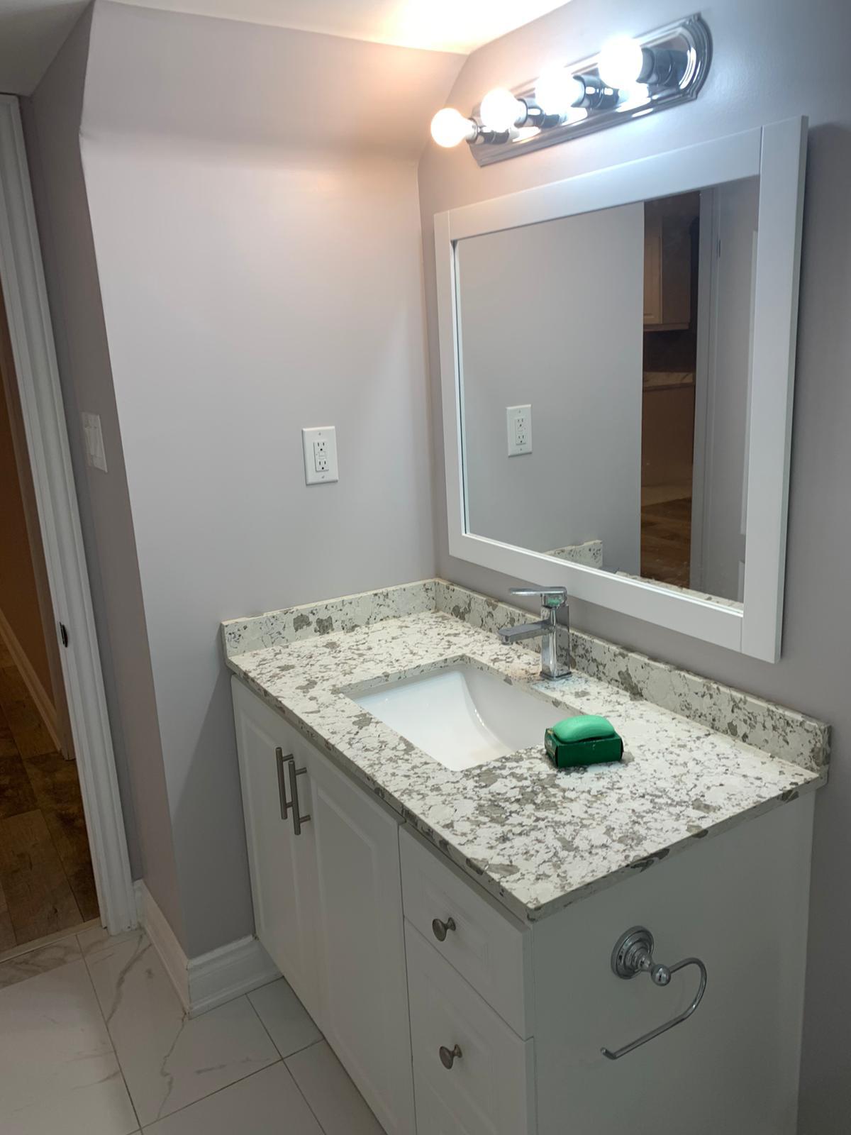 Luxury bathroom with modern vanity, mirrors, and lighting